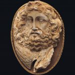 A GREEK CORAL CAMEO OF ZEUS HELLENISTIC PERIOD, CIRCA 2ND CENTURY B.C.