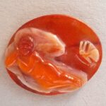 Cameo; sardonyx; Cupid lying asleep, approached from right by butterfly; figure of Cupid in a red stratum.