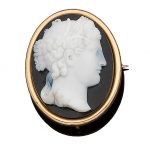 A mid 19th century hardstone cameo brooch The oval banded agate plaque carved to depict the goddess Demeter