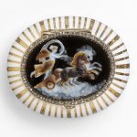 Oval gold bonbonnière, with bands of white enamel and gold, the hinged lid with a layered agate cameo carved with Aurora