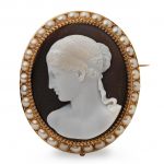 An early 19th century gold, half-pearl and onyx cameo brooch/slide, possibly by Michelini