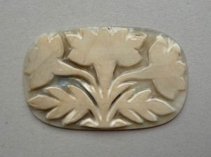 Cameo; chalcedony; rectangular; oval corners; plant with three flowers and two leaves