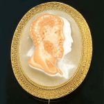 A mid-Victorian Etruscan style cameo brooch circa 1860
