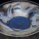 Round opalescent moulded coupe-plate form platter, decorated with five swirling nymph or mermaid figures in various poses, around an undecorated centre.