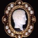 Pendant inset with cameo; onyx; head of Hercules; enamelled gold pendant setting with diamonds and pearls.