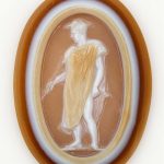 Oval sardonyx cameo in three layers: pale brown over white over brown.