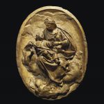 AN OVAL GILT TERRACOTTA RELIEF OF THE VIRGIN AND CHILD